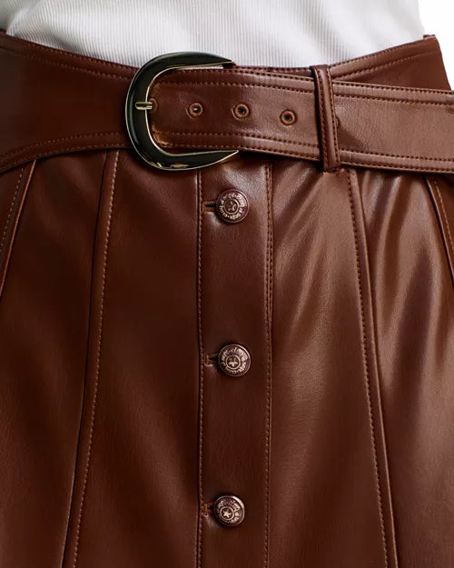 Close-up view of the Espresso brown vegan leather fabric, front button closure, and waist belt buckle on the Cinq à Sept Briony skirt.
