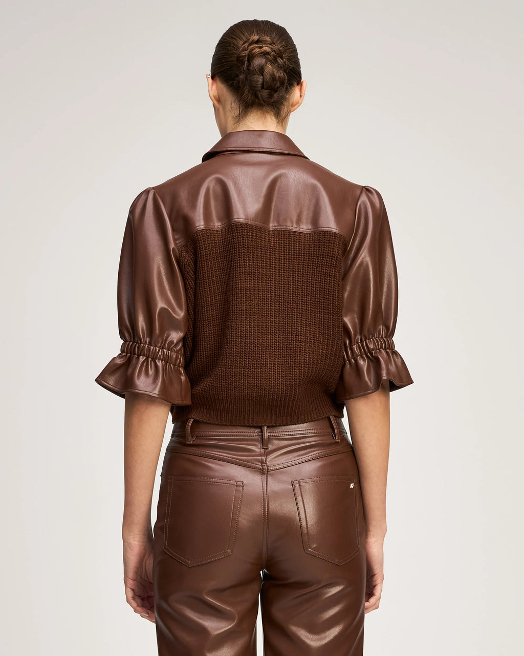 Back view of a model wearing the Cinq à Sept Knit Holly Combo Jacket, highlighting the cropped hem and back knit structure.