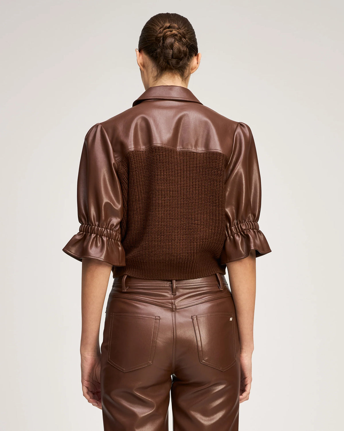 Back view of a model wearing the Cinq à Sept Knit Holly Combo Jacket, highlighting the cropped hem and back knit structure.